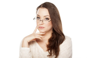 pensive serious young woman with glasses